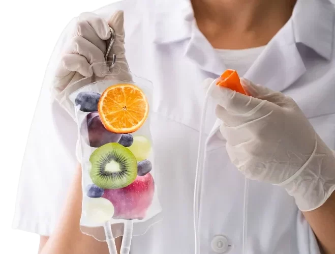 nurse holding an iv drip with fruits inside
