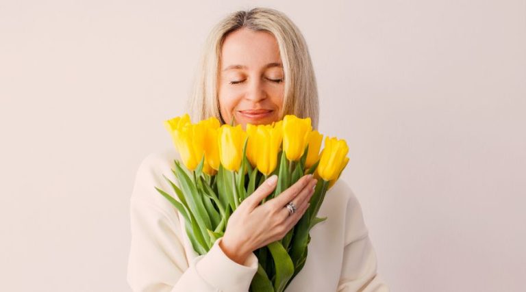 woman in 40s smiling with beautiful glowing skin